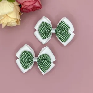 Detailed view of green gingham white ribbon hair bows, lovely sweet styling for children.