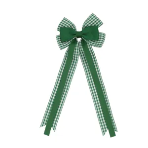 Green plaid ribbon bow hair clip detail, elegant children's hair accessory with long tails.