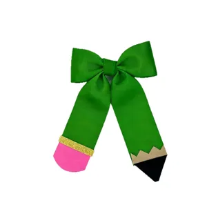 Green ribbon pencil bow hair clip, cute back to school hair accessory for young girls.
