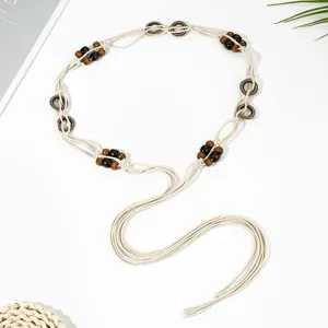 Boho woven waist chain with wooden beads and metallic rings, detailed view of bohemian belt decor.