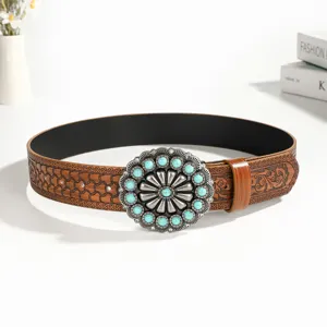 Bohemian retro carved leather belt with turquoise metal buckle, stylish ethnic waist accessory.