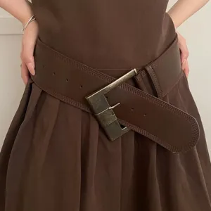 Retro brown wide leather belt detail shot showcasing vintage metallic buckle and slim waist fit.