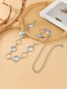 Silver metal disc chain belt detail showing intricate geometric links and adjustable clasp.