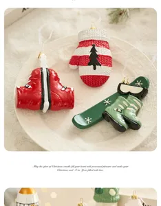 Christmas ornament detail, resin mitten and ski boots hanging decor for holiday tree setup.