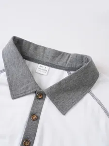 Close-up detail of summer polo shirt collar, grey and white contrast design with buttons.