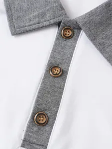 Close-up detail of contrast color polo shirt collar, placket and buttons texture quality view.