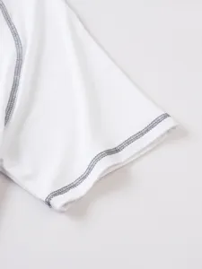 White short sleeve top detail view, featuring contrast grey stitching and soft breathable fabric.