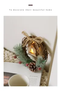Christmas wreath decoration with pinecones berries and light wooden cabin for home decor