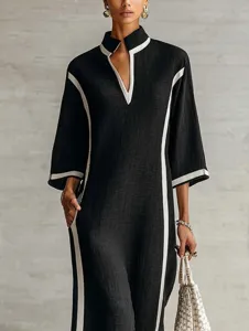 Black stand collar midi dress with white trim, V-neck long sleeve casual elegant outfit.
