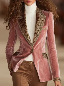 Close-up detail shot of pink velvet blazer with stylish leopard print lapels and metal buttons.