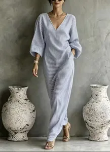 Close-up view of striped V-neck long dress detail, showing resort style and elegant lantern sleeves.