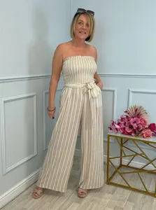 Detailed view of women's casual strapless striped jumpsuit with waist tie and wide leg fit.