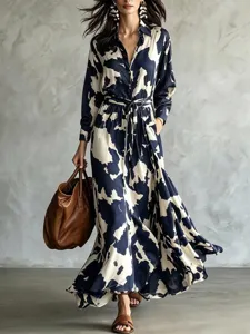 Detailed shot of the cow print long sleeve shirt maxi dress with waist tie and fluid skirt.