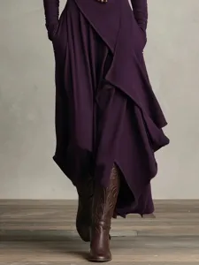 Detail view of women's long sleeve crossover high neck dress in deep purple with boots.