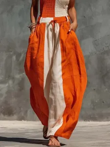 Close-up of the stylish color-blocked cotton linen jumpsuit showing drawstring waist and pockets.
