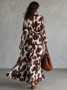 Stunning brown and white cow print long sleeve shirt dress with belted waist and flowing maxi hem.