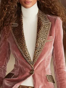 Detail shot of pink gold velvet blazer featuring stylish leopard print lapels and long sleeves.
