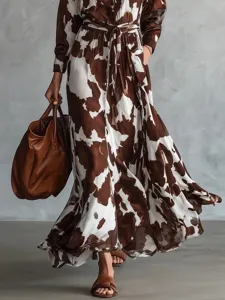 Brown white cow print long sleeve shirt maxi dress with waist cinching and large swing.