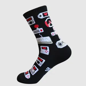 Detailed close-up shot of black gaming theme knitted crew socks with retro console patterns.