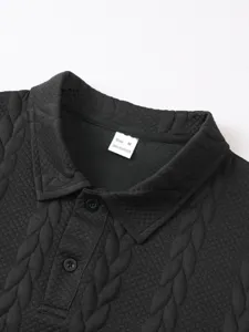 Men's black jacquard short sleeve polo shirt collar detail view showing size and material tag.