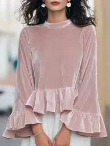 Pink velvet long sleeve top detail showing mock neck, soft texture and elegant ruffle hem.
