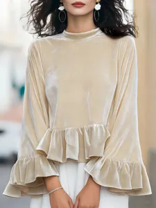 Velvet long sleeve blouse with round neck and ruffled hem. Elegant women's apparel for daily wear.