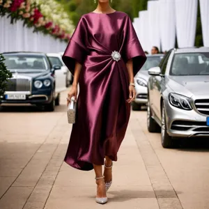 Elegant satin maxi dress for women featuring delicate rhinestone brooch detail long sleeves.