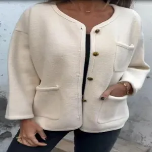 Chic detail of cream wool-blend cardigan with gold buttons and patch pockets for women.