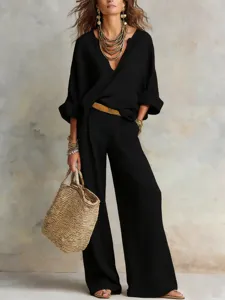 Chic European casual linen loose resort outfit featuring a stylish black V-neck top and trousers.