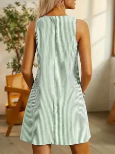Detail view of a green and white striped sleeveless mini dress, showcasing the stylish back fit.