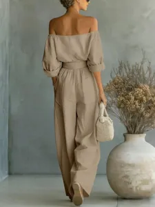Detail view of the elegant khaki off-the-shoulder jumpsuit with wide-leg pants and belt.