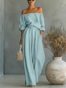 Detail view of the light blue off-shoulder top and wide leg pants set showcasing fabric.