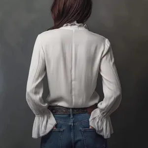 Women's white long-sleeve blouse with ruffled collar and cuffs paired with blue jeans, back view.
