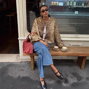 Women's chic leopard print short faux fur jacket, stylish autumn winter outerwear outfit.