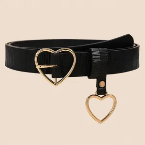 Close-up detail of women black leather belt with gold heart buckle and hanging heart pendant.