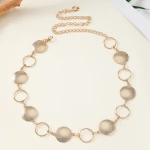 Gold metal waist chain belt for women, geometric circular disc and ring link body jewelry.
