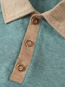 Detailed close-up view of a green polo shirt featuring a contrast collar and knit fabric.