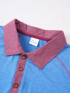 Close-up detail of contrast color polo shirt collar and button placket, blue and red fabric.