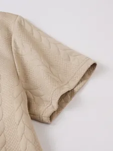 Close-up detail of men's casual jacquard short sleeve polo shirt fabric and cuff texture.