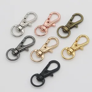 Detail view of metal swivel lobster clasps in multi-colors for DIY keychains and bag straps.