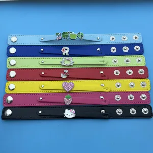 Detailed view of multi-color leather snap bracelets with cute charms and metal buttons.
