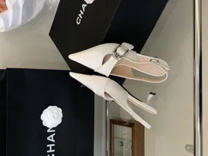 White patent leather pointed toe slingback kitten heels with metal buckle detail for women