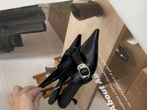 Elegant black pointed slingback kitten heels with stylish metal buckle detail. Perfect for chic daily wear.