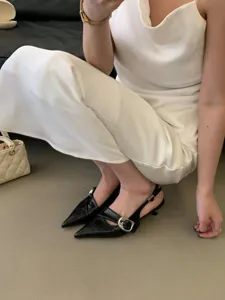 Women's chic pointed toe slingback kitten heels paired with elegant white slip dress.