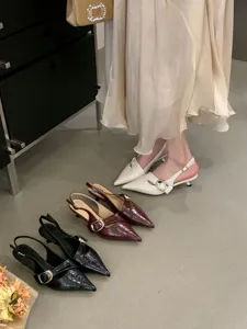 Detailed view of women slingback pointed kitten heels in white, wine red, and black colors.