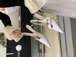 Elegant white pointed-toe slingback heels with metal buckle detail, premium fashion women pumps.