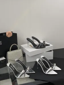 Detailed view of stylish pointed toe stiletto high heels with clear PVC strap and buckle.