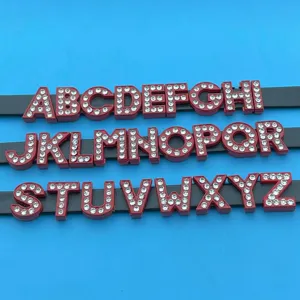 Close-up detail view of red rhinestone alphabet letters on black straps, ideal for DIY jewelry.
