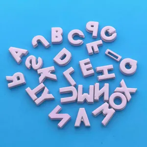 Close-up detail of pink alphabet letter beads, perfect for DIY jewelry making and crafts.