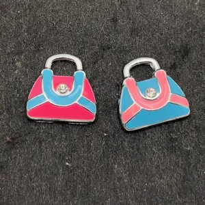 Detailopname van kleurrijke metalen handtasbedels voor handwerk en unieke DIY accessoires.